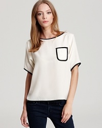 This silk Tucker top features smart black piping and at the neckline, sleeves and chest patch pocket--a sophisticated way to work the color-blocking trend at the office. This silk Tucker top features smart black piping and at the neckline, sleeves and chest patch pocket--a sophisticated way to work the color-blocking trend at the office.