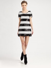 Daringly short dress surrounded by glitzy sequins that form contrasting stripes. RoundneckShort sleevesFully linedAbout 16 from natural waist96% polyester/4% spandexDry cleanImportedModel shown is 5'10 (177cm) wearing US size Small. Daringly short dress surrounded by glitzy sequins that form contrasting stripes. RoundneckShort sleevesFully linedAbout 16 from natural waist96% polyester/4% spandexDry cleanImportedModel shown is 5'10 (177cm) wearing US size Small.