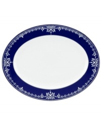 A show-stopping oval platter from Marchesa by Lenox, this Empire Indigo dinnerware wows everyone around the formal table with a bedazzling platinum pattern in fine bone china.