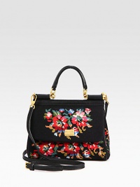 A cotton cross-stitch style in a floral design with leather trim and a convenient detachable strap.Leather top handle, 3 dropDetachable adjustable leather shoulder strap, 21½-25½ dropMagnetic snap flap closureOne inside open pocketSatin lining8W X 6¾H X 3½DMade in Italy A cotton cross-stitch style in a floral design with leather trim and a convenient detachable strap.Leather top handle, 3 dropDetachable adjustable leather shoulder strap, 21½-25½ dropMagnetic snap flap closureOne inside open pocketSatin lining8W X 6¾H X 3½DMade in Italy
