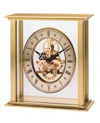 Watch as the gears shift inside this revealing tabletop clock by Bulova. A brass-finished metal frame houses a floating gold tone skeleton dial with black Roman numerals and two hands. Watch as the gears shift inside this revealing tabletop clock by Bulova. A brass-finished metal frame houses a floating gold tone skeleton dial with black Roman numerals and two hands.