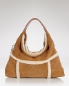 UGG® Australia tackles the textured trend with this lush hobo, crafted of a cool mix of suede with shearling trims. Carry it to send a mixed material message.