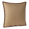 This decorative throw pillow adds texture in neutral linen with soft suede trim.
