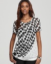 Classic houndstooth gets a contemporary refresh as a draped, sheer overlay infuses this DKNYC top with modern edge.