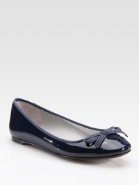 Patent leather staple with grosgrain trim and a delicate bow. Patent leather upperLeather lining and solePadded insoleImported Patent leather staple with grosgrain trim and a delicate bow. Patent leather upperLeather lining and solePadded insoleImported