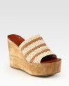 Artfully crafted woven leather upper joined by an earthy wooden wedge and platform. Wooden wedge, 4 (100mm)Wooden platform, 2 (50mm)Compares to a 2 heel (50mm)Woven leather upperLeather liningRubber soleImported