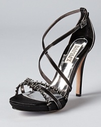 Spectral crystals dot the front of Badgley Mischka's Gelsey sandals, a shimmering design with effortless evening style. Spectral crystals dot the front of Badgley Mischka's Gelsey sandals, a shimmering design with effortless evening style.