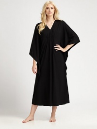 An elegant design with a gathered front and ruffled sides for comfortable, yet sophisticated look. V-neckThree-quarter length kimono sleevesGathered frontRuffled sidesPull-on styleAbout 50 from shoulder to waist67% polyester/33% rayonMachine washImported 