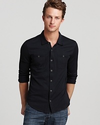 The button-down silhouette of this sport shirt contrasts with the soft knit blend of plush silk and cotton for a luxe, innovative design from John Varvatos. The button-down silhouette of this sport shirt contrasts with the soft knit blend of plush silk and cotton for a luxe, innovative design from John Varvatos.