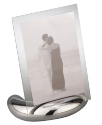 Keep memories fresh in the modern Elbow picture frame. A sculpted metal base turns back in an elegant curve, fitted with sheets of clear glass for displaying any photo, vertical or horizontal. Designed by Neil Cohen for Nambe. Keep memories fresh in the modern Elbow picture frame. A sculpted metal base turns back in an elegant curve, fitted with sheets of clear glass for displaying any photo, vertical or horizontal. Designed by Neil Cohen for Nambe.