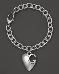 Gucci's signature sterling silver charm bracelet with logo heart charm. Gucci's signature sterling silver charm bracelet with logo heart charm.