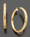 Regal 14k gold hoops with elegant diamond-cut accents. Approximate diameter: 1-1/2 inches.
