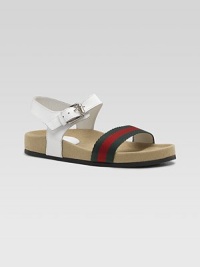 Classic webbing stripes in front are joined by smooth leather in the back of this super comfy, super stylish sandal.Webbed fabric and leather upperBuckle ankle strapGolden hardwareGG rubber soleMade in Italy