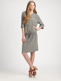 Utility-chic has never been more effortless than this dropped-waist drawstring shift styled with cargo pockets, all in a soft jersey knit.Button-front band collarDropped shouldersThree-quarter roll-tab sleevesChest pocketsViscoseAbout 19 from natural waistMachine washImported of Italian fabricModel shown is 5'11 (180cm) wearing US size Small. Utility-chic has never been more effortless than this dropped-waist drawstring shift styled with cargo pockets, all in a soft jersey knit.Button-front band collarDropped shouldersThree-quarter roll-tab sleevesChest pocketsViscoseAbout 19 from natural waistMachine washImported of Italian fabricModel shown is 5'11 (180cm) wearing US size Small.