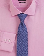 A clean, gently textured dress shirt is cut with a classic fit. ButtonfrontRegular fitSpread collarCottonDry cleanImported