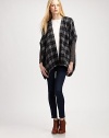 Give your cool-weather wardrobe a hit of flair with this plaid, mixed-media poncho with dropped shoulders and a lengthy silhouette. Open frontPoncho sleeves with rib-knit cuffsContoured asymmetrical hemAbout 29 from shoulder to hem50% acrylic/30% wool/20% nylonHand washImportedModel shown is 5'10 (177cm) wearing US size XS/S.