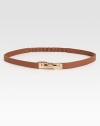 Waist defining and beyond chic, this leather skinny belt is flawlessly complemented by a brass buckle.Brass buckleLeatherLength, 27Width, ½Imported
