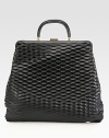 A roomy design in an edgy perforated leather style.Double top handles, 3¼ dropTop clasp closureSuede lining14¾W X 12½H X 2DMade in Italy