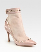 Studded patent leather pairs with suede in this lust-worthy point toe silhouette. Patent leather-covered heel, 3¼ (80mm)Suede and patent leather upper with metal studsPoint toeBack zip and button closureLeather liningBuffed leather solePadded insoleMade in ItalyOUR FIT MODEL RECOMMENDS ordering one half size up as this style runs small. 