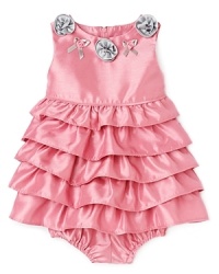 She'll be the princess of the ball (or the birthday party) with this glossy ruffled dress embellished with silver rosettes and satin bows. She'll be the princess of the ball (or the birthday party) with this glossy ruffled dress embellished with silver rosettes and satin bows.