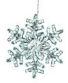 Let it glow. Twinkling clear lights fill a larger-than-life snowflake in this whimsical Christmas decoration from Kurt Adler.