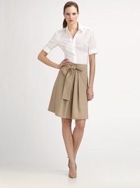 A crisp poplin skirt featuring a flattering silhouette and a self-tie belt that creates an ultra-feminine bow.Self-tie bow beltPleated front centerConcealed back zipperAbout 23 longCottonDry cleanImported Model shown is 5'11 (180cm) wearing US size 4. 