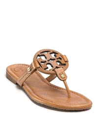 Bright, tropical pink thongs, finished with a bold Tory Burch Logo, remind us of lazy beach vacations. Bright, tropical pink thongs, finished with a bold Tory Burch Logo, remind us of lazy beach vacations.