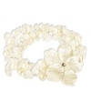 Prim petals. This pretty stretch bracelet combines three strands of cultured freshwater pearls (6-7 mm), white shells and cultured Mother of Pearl (46-3/4 mm) with a sweet flower accent. Set in sterling silver. Approximate length: 7-1/2 inches. Approximate diameter: 2 inches.