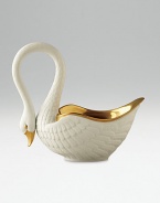 This graceful swan in white porcelain and 14kt gold accents is perfect for serving or decoration. Hand-gilded 7 edition: 3W X 7H X 6½D 13 edition: 6W X 13H X 13D Made in Portugal