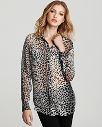 Spots abound on this chic animal print Equipment blouse rendered in breezy silk. Spots abound on this chic animal print Equipment blouse rendered in breezy silk.
