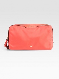 Glossy patent leather accents this durable nylon design.Top zip closureOne outside zip pocketCotton lining7½W X 4H X 2¾DImported Glossy patent leather accents this durable nylon design.Top zip closureOne outside zip pocketCotton lining7½W X 4H X 2¾DImported