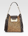 A beautiful leopard print hair calf panel with supple leather sides in a roomy carryall design.Leather and chain shoulder strap, 9 dropTurnlock strap closureDetachable tassel accentTwo outside open pockets, one under strap and one on backOne inside zip pocketTwo inside open pocketsOne pen holderFully lined13W X 12¾H X 4DImported