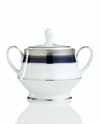 Formal white fine china displays a dramatic combination of scrolling leaves on shimmering platinum and an inner band of intense cobalt blue. Dishwasher safe. Formal white fine china displays a dramatic combination of scrolling leaves on shimmering platinum and an inner band of intense cobalt blue. Dishwasher safe.