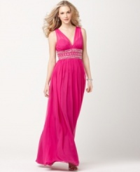 A wide waist with exotic beading gives this JS Boutique gown a touch of global flair while a slightly pleated bust and flowing skirt lend classic appeal. A wide waist with exotic beading gives this JS Boutique gown a touch of global flair while a slightly pleated bust and flowing skirt lend classic appeal.