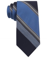 With a cool palette of colors, this Calvin Klein striped skinny tie makes a solid statement. With a cool palette of colors, this Calvin Klein striped skinny tie makes a solid statement.
