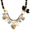 Take good taste to the next level in this statement maker. Betsey Johnson's not-so-subtle style combines a feminine mix of heart charms, clear and blue crystals, and a bold black grosgrain ribbon. Set in gold-plated mixed metal. Approximate length: 16 inches + 3-inch extender. Approximate drop: 2 inches.