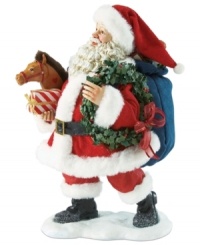 Here Comes Santa Claus! Celebrate the arrival of jolly old Saint Nicholas with this festive figurine featuring Santa and his bag of gifts.