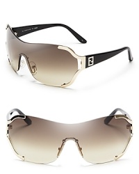 Fendi's shield logo sunglasses are futuristic and fashion-forward in warm shades of gold and brown.