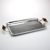 This stylish serving tray features dark amber glass handles and hand-polished metal - perfect for drinks and appetizers.