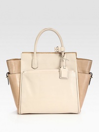 An elegant, top-handle tote designed to balance function and luxury with a soft geometry.Double top handles, 4½ dropDetachable adjustable shoulder strap, 21½-23 dropTop zip closureThree outside open pocketsOne detachable zip pouchOne inside zip pocketTwo inside open pocketsLeather lining9½W X 10H X 5DImported An elegant, top-handle tote designed to balance function and luxury with a soft geometry.Double top handles, 4½ dropDetachable adjustable shoulder strap, 21½-23 dropTop zip closureThree outside open pocketsOne detachable zip pouchOne inside zip pocketTwo inside open pocketsLeather lining9½W X 10H X 5DImported