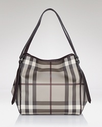 This modern tote in Burberry's iconic check makes a chic statement work or weekend. This modern tote in Burberry's iconic check makes a chic statement work or weekend.