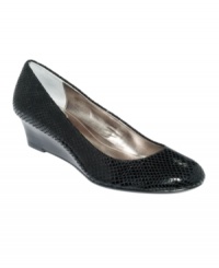 Calvin Klein's Saxton wedge pumps are polished and pretty with just the right amount of texture and height. Calvin Klein's Saxton wedge pumps are polished and pretty with just the right amount of texture and height.