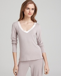 A long sleeve pajama top with a satin trim V-neckline. Pair it with Calvin Klein's matching pajama pants to complete the look.