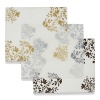 A floral branch motif in metallic colors accent the edges of this translucent placemat.