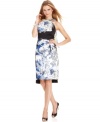 T Tahari's dress is adorned with a vibrant print and on-trend touches, like a high-low hem and a flyaway tie at the shoulder.