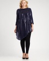 This silk top with allover sequins will move with you as its draped, asymmetrical hem provides a flattering and feminine silhouette.BoatneckThree-quarter sleevesAsymmetrical hemAllover sequinsConcealed back zipperFully linedAbout 35 from shoulder to hemSilkDry cleanImported