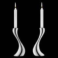 Georg Jensen Cobra candleholders in polished stainless steel. Designed by Constantin Wortmann, who took the familiar silhouette of the traditional candleholder and reinvigorated it with organic curves. It's snakelike strength is shared by its' name.