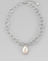 A large, lustrous white pearl drop dangles with creamy iridescence from a silvery chain of hammered open links. 22mm white baroque organic man-made pearl Rhodium-plated sterling silver Length, about 16, with 2 extender Lobster clasp Made in Spain