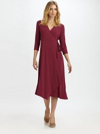 Universally flattering, this wrap dress offers a slightly-relaxed fit.V-neckThree-quarter sleevesWrap-front designAsymmetrical hemAbout 47 from shoulder to hem92% rayon/8% Lycra®Machine washMade in USA of imported fabric