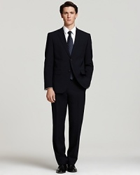 Two button, wool sport coat with center back vent, fully lined. Contemporary cut with padded shoulders. Pick-stitched lapel on notched lapel; front flap pockets. Trousers have a slimmer, more modern silhouette with a slightly tapered leg and unfinished hem. Front lined to the knee. Two button, wool sport coat with center back vent, fully lined. Contemporary cut with padded shoulders. Pick-stitched lapel on notched lapel; front flap pockets. Trousers have a slimmer, more modern silhouette with a slightly tapered leg and unfinished hem. Front lined to the knee.